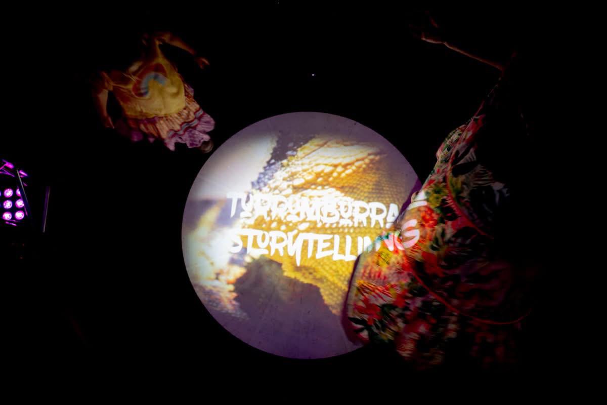 Performer with Turrumburra projection backdrop